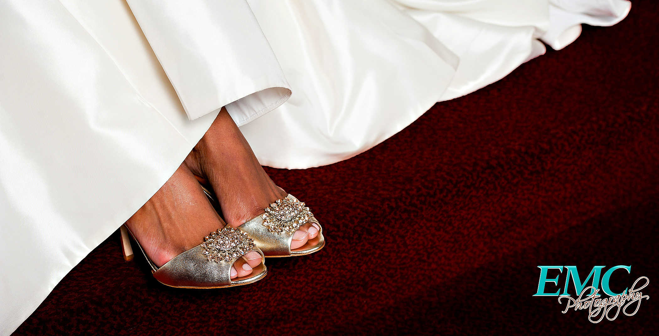 Bride shows off her pretty shoes on her wedding day, peeking out from underneath her dress